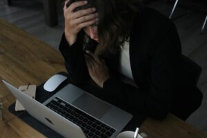 a Woman Stressed at her computer.